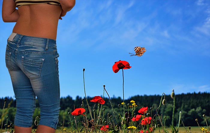 Natur. Bild einer Frau, rote Mohnblumen unter einem blauen Himmel. Fotografie von Lothar Seifert